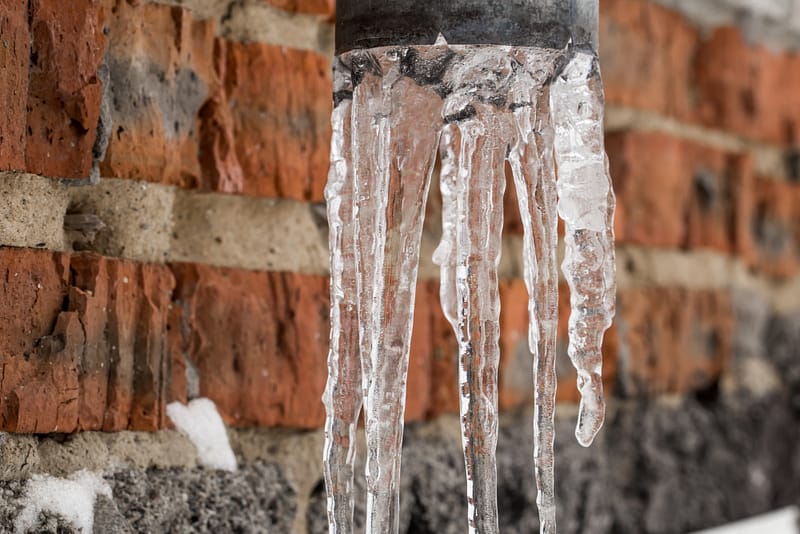 Icicles hanging from a frozen pipe